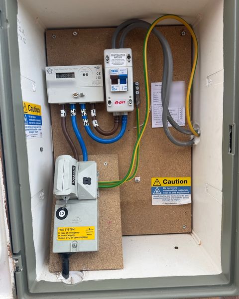 Example: an outdoor meter cupboard opened up, showing the meter, the isolator, the main fuse and the cables around them